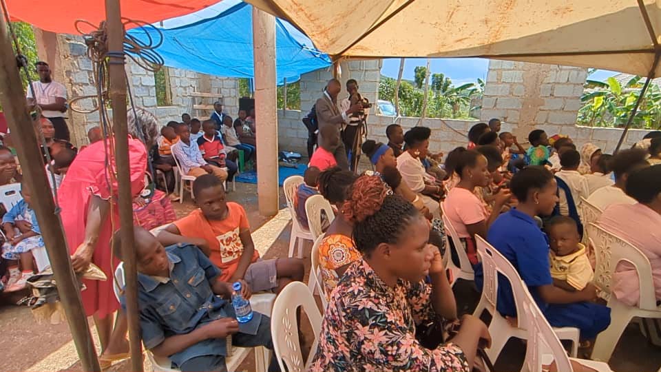 Church members gathered under tents for worship